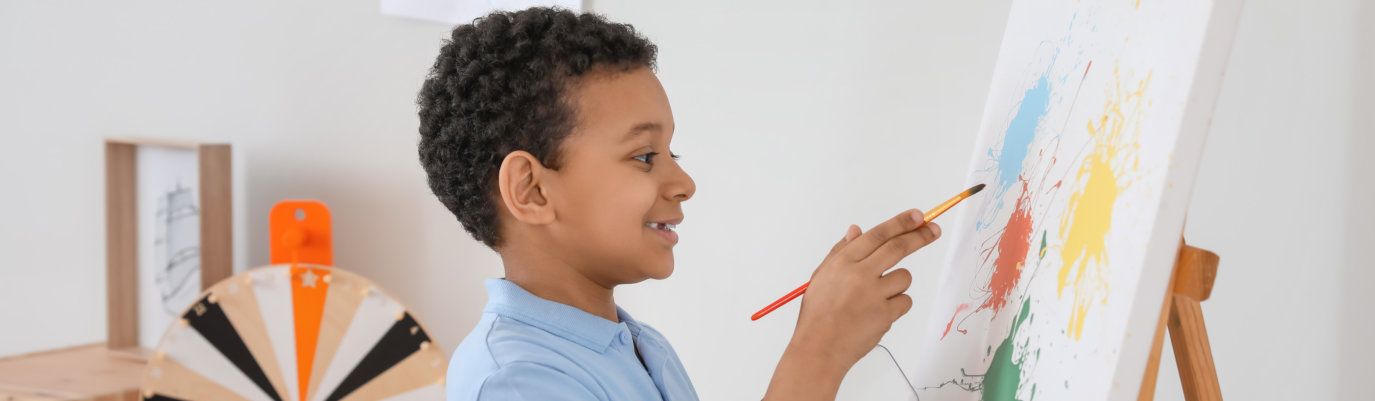 happy student doing his painting