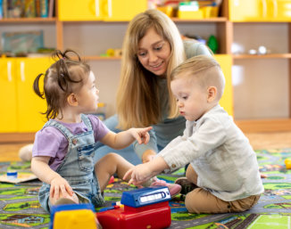 teacher with her students playing