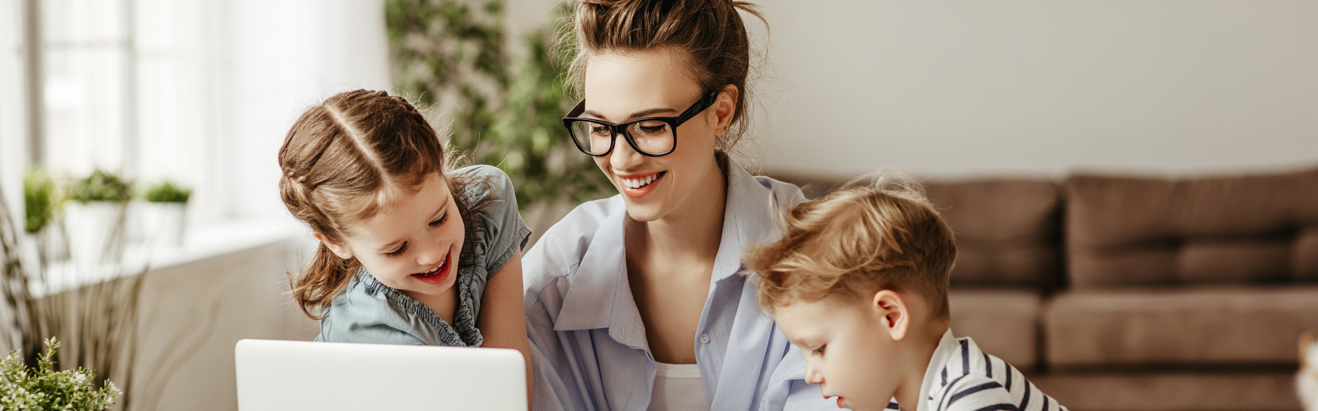 mother using laptop with her children